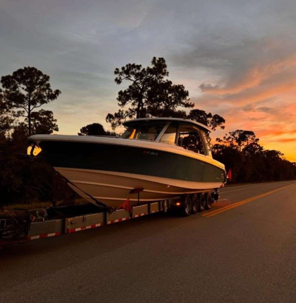 NexGen Auto Transport providing expert boat trailer transport service with a heavy-duty truck hauling a vessel securely on a custom trailer.