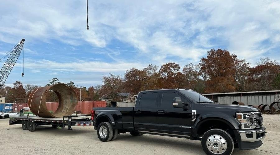 NexGen Auto Transport handling equipment transports using a heavy-duty truck to move industrial gear across state lines.