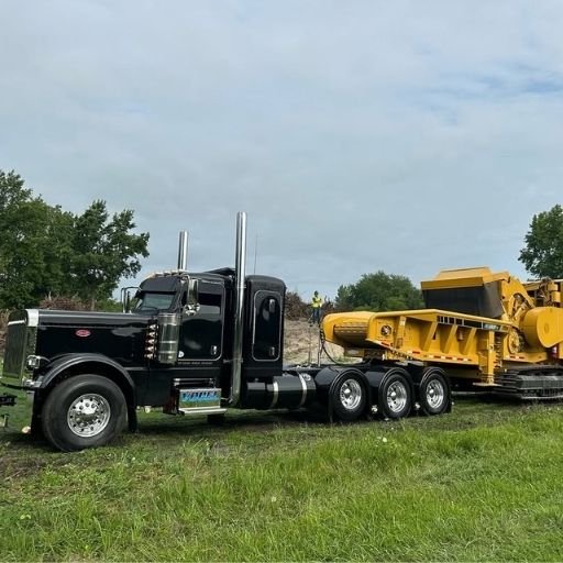 NexGen Auto Transport, a trusted heavy machinery transportation company, moving oversized excavators on a professional-grade lowboy trailer.